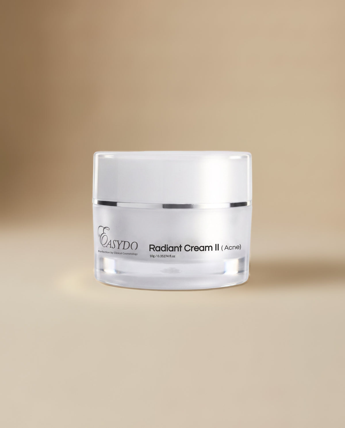 A clear cosmetic jar of Easydo Radiant Cream II (Acne) with a white lid, set against a warm beige gradient background.
