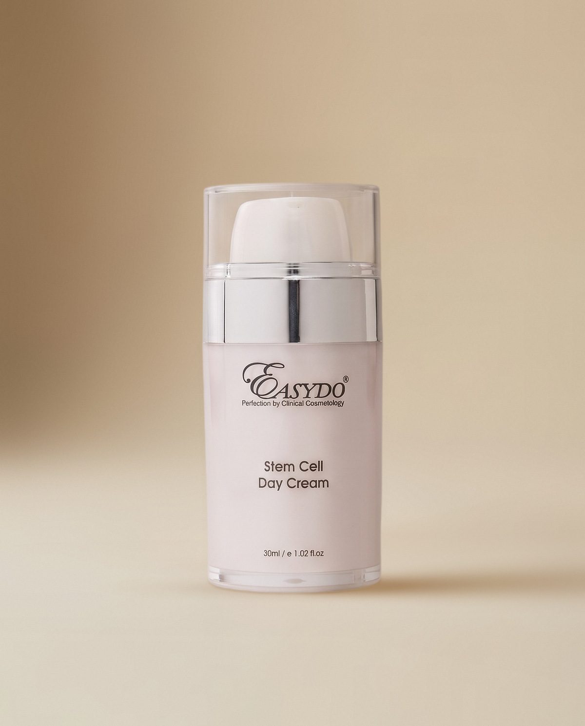 A clear cosmetic bottle with a white pump and a silver collar, labeled 'Easydo Stem Cell Day Cream', centered on a warm beige background.