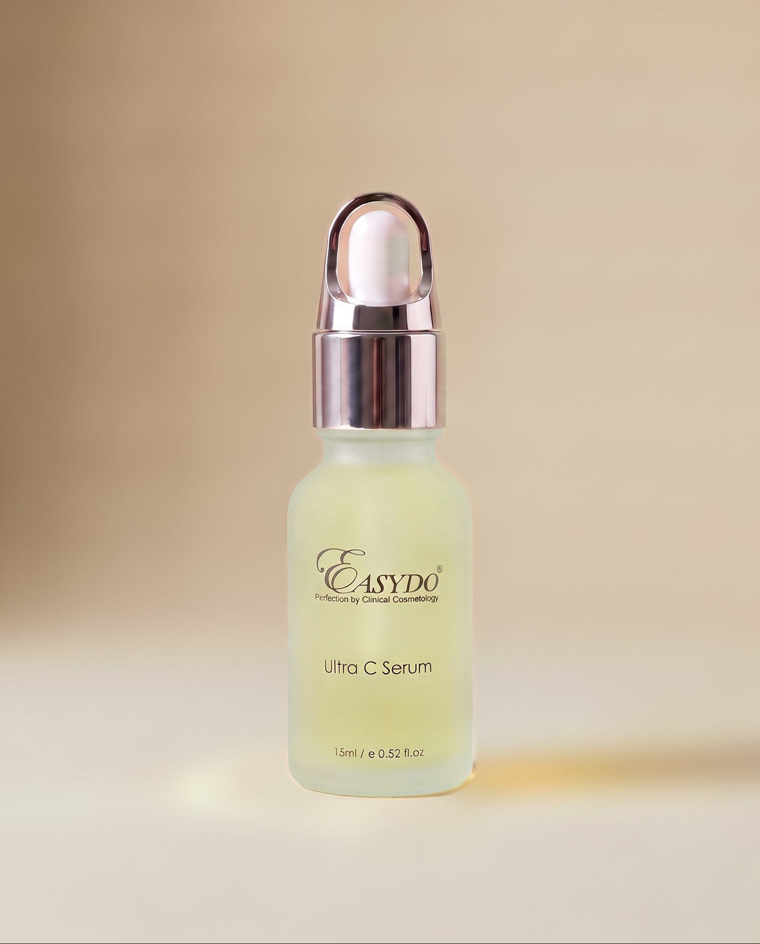 A small frosted glass dropper bottle of Easydo Ultra C Serum with a metallic rose gold cap, set against a soft beige background.
