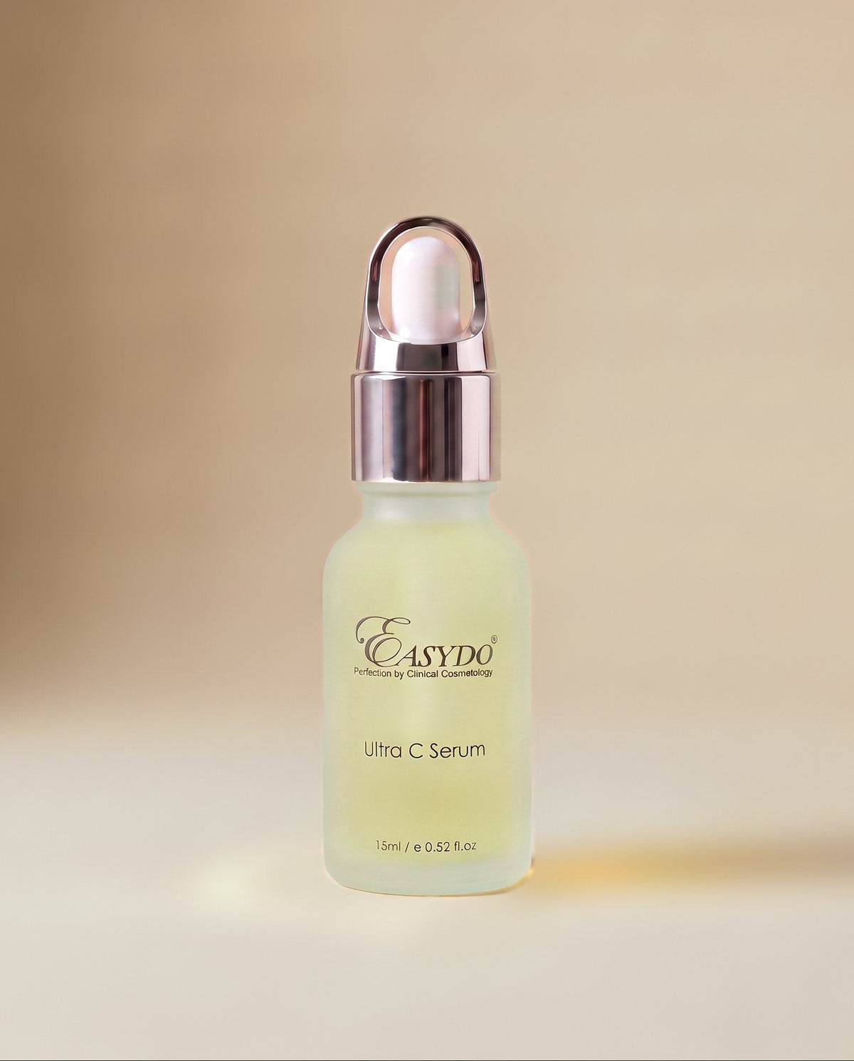 A small frosted glass dropper bottle of Easydo Ultra C Serum with a metallic rose gold cap, set against a soft beige background.